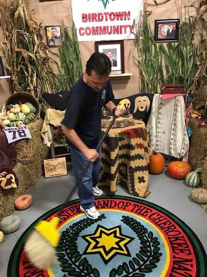 Patrick Lambert sweeping the EBCI seal at Birdtown Community booth, Cherokee Indian Fair