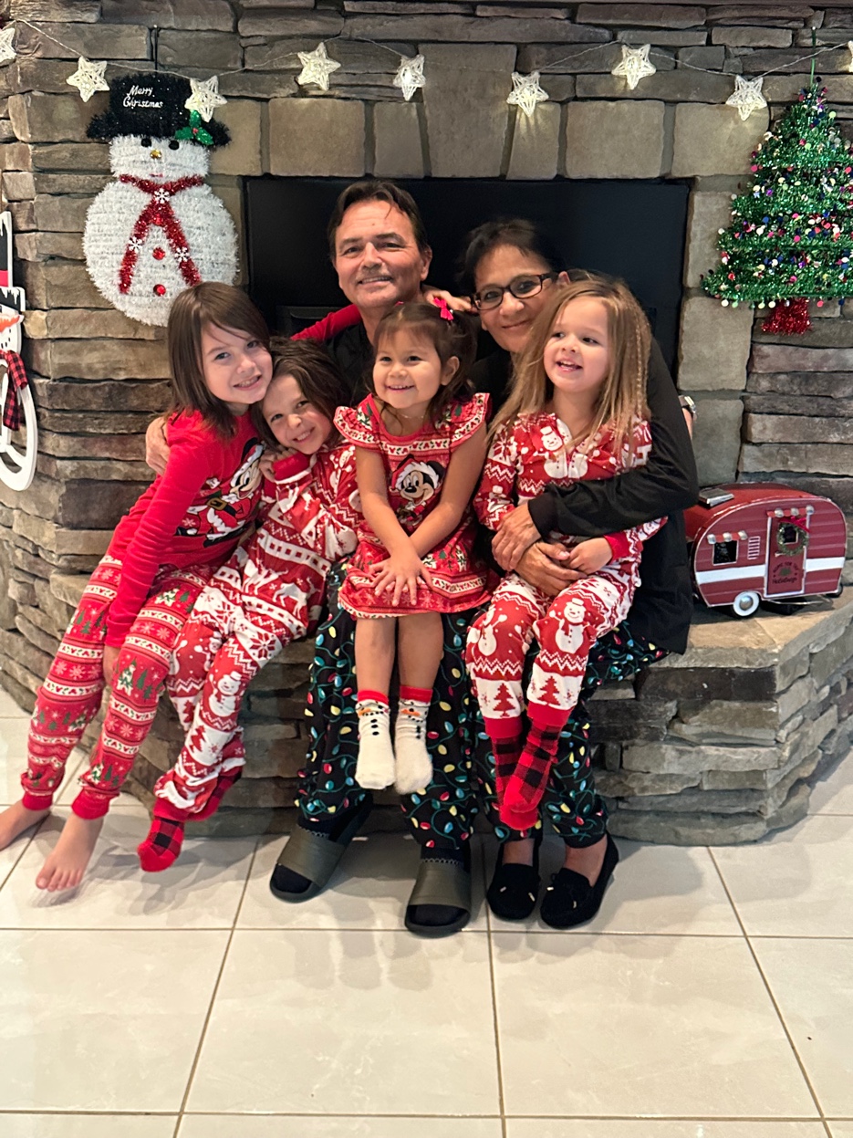 Patrick and Cyndi with Rhett, Henrik, Ava, and Lilou in matching Christmas pajamas