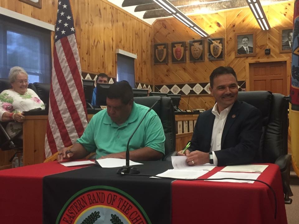 Chief Lambert and Chairman Taylor signing the tribal debt payoff documents in council chambers