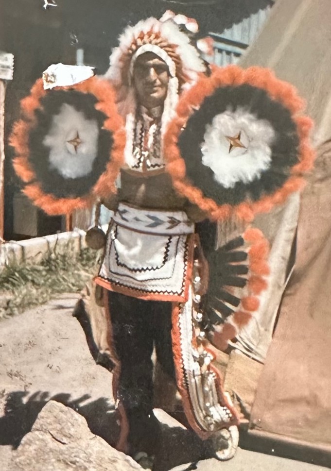 Henry Lambert in full regalia at his roadside stand on the Qualla Boundary