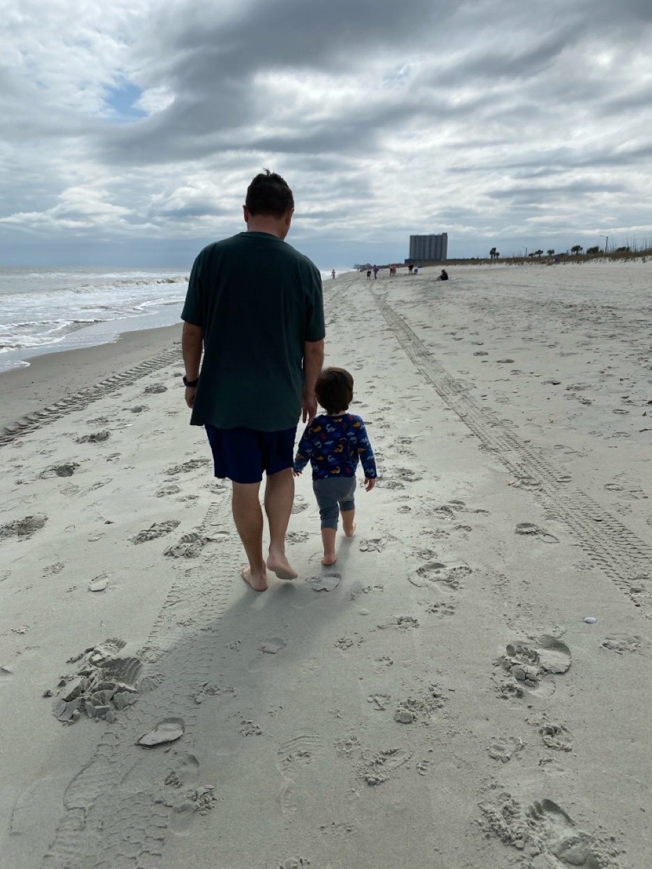 PopPop and Henrik walking on the beach at Myrtle Beach